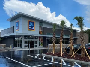 The image is of a freshly painted Aldi store building showcasing the work of our Pinellas County commercial painters.